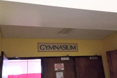 Looking west at gymnasium sign